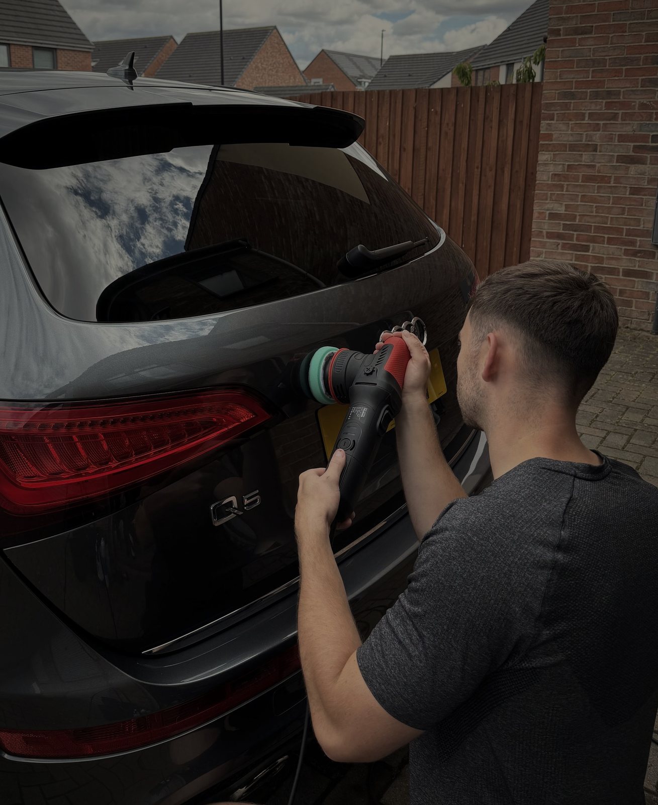 Machine polishing an Audi Q5 during an ARDEN Enhancement Detail